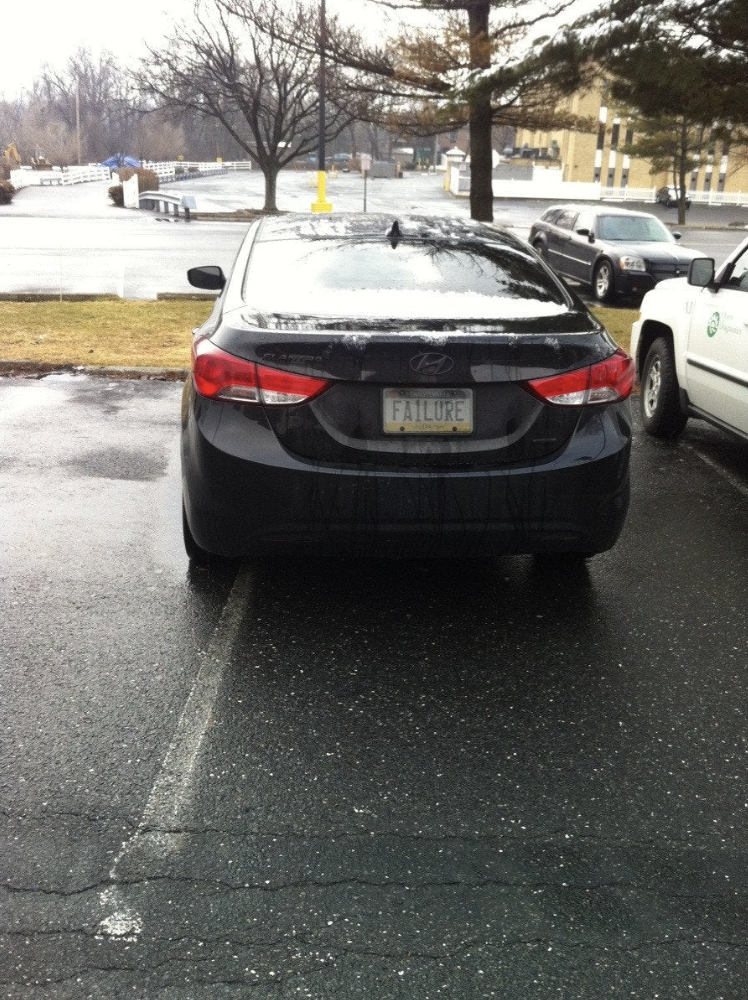 Car with license plate reading &quot;FAILURE&quot;