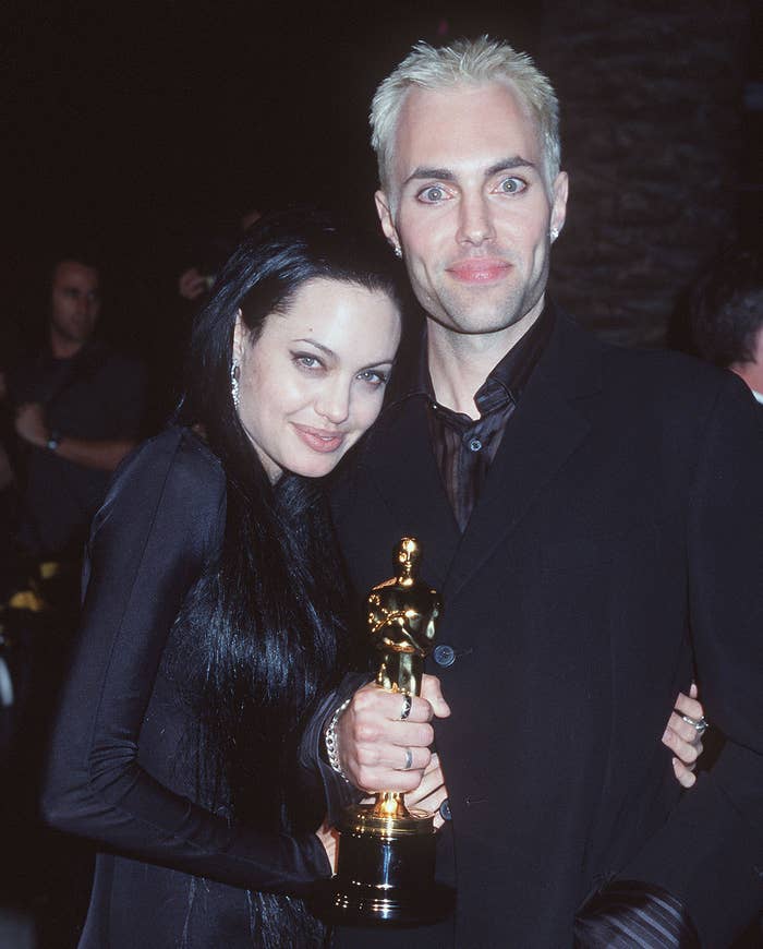 Close-up of Angie and James embracing and holding an Oscar