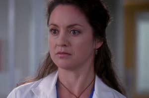 TV character in medical attire with a stethoscope, concerned expression