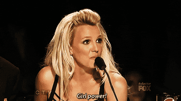 Britney Spears at a judging panel, saying &quot;Girl power!&quot; into a microphone
