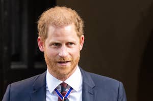 Prince Harry in a dark suit with medals, attending a formal event