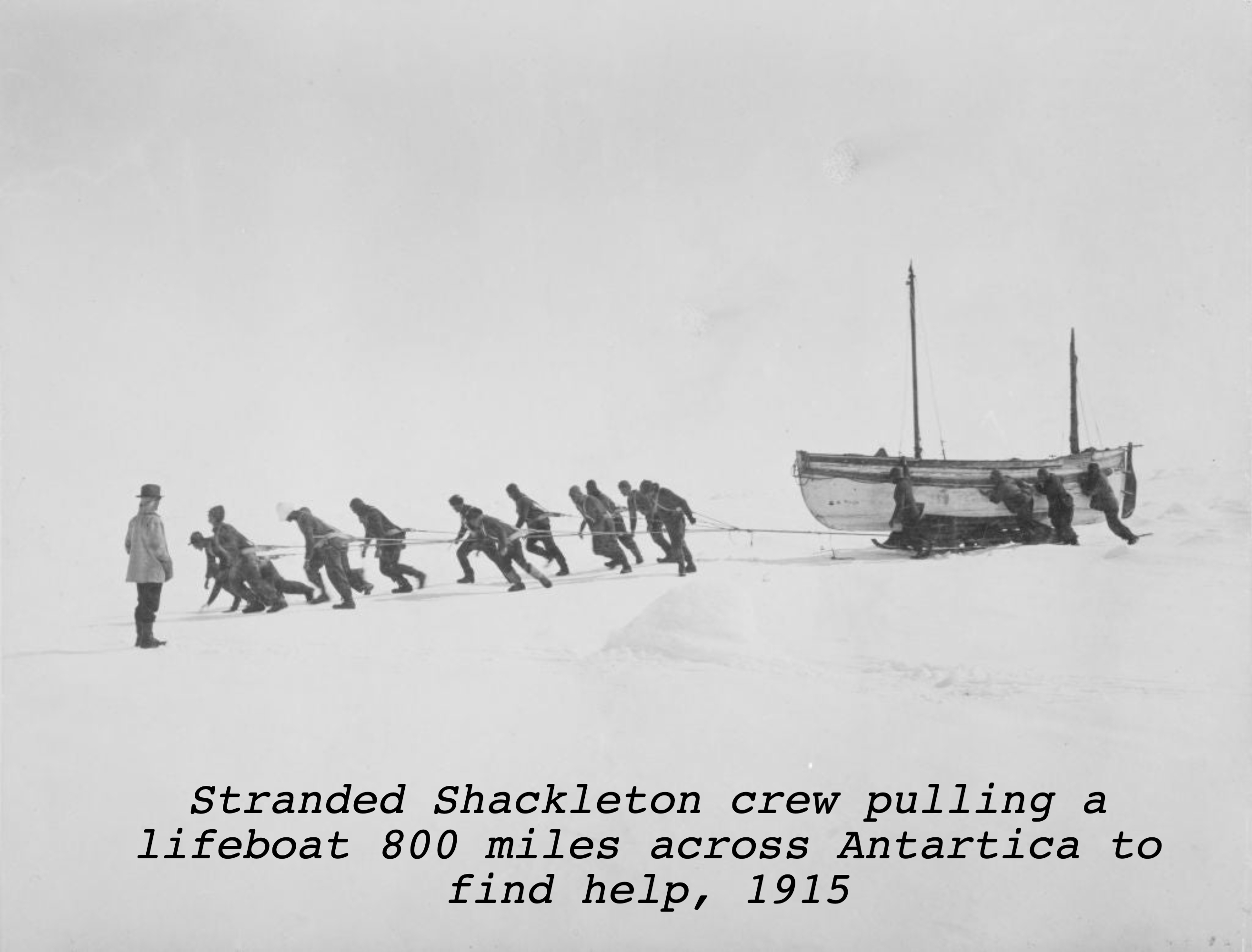 A group of people pull a large boat across a snowy landscape while another person watches