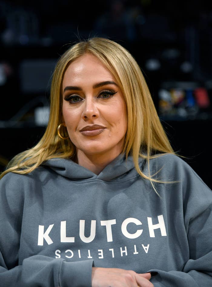 Adele wearing a grey &quot;Klutch Athletics&quot; hoodie, looking at the camera