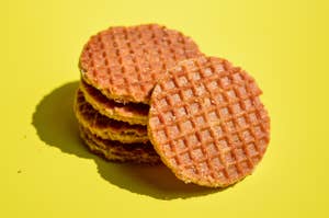 A stack of round, crispy stroopwafels with on a plain background