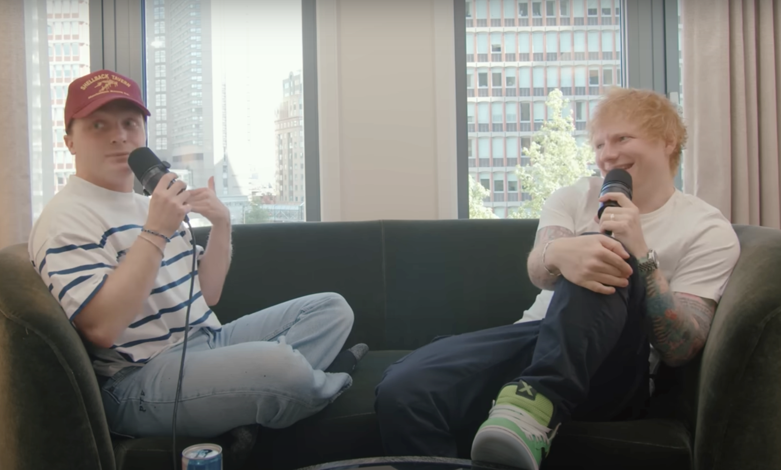 Ed Sheeran and Jake Shane sit on a couch during their interview