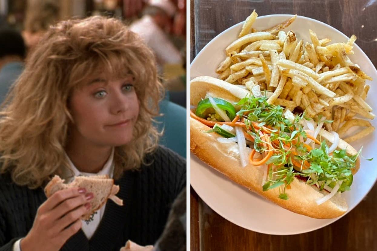 Woman (unknown) with curly hair holding a sandwich; next to it, a plate with a sandwich filled with vegetables and fries