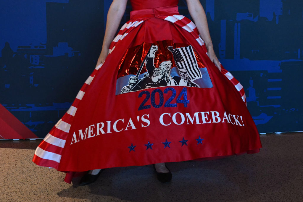 A woman in a dress adorned with American flag motifs shows the year &quot;2024&quot; and &quot;America&#x27;s Comeback!&quot;