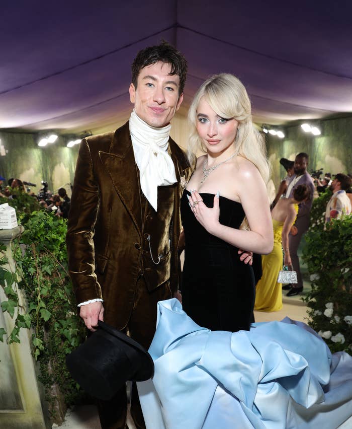 Barry Keoghan in a Victorian-inspired outfit and Sabrina Carpenter in a strapless gown with a voluminous train at a formal event