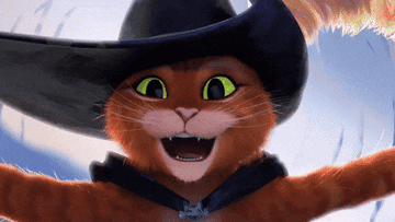 Gato con Botas, personaje de la película animada &quot;Shrek&quot;, sonríe ampliamente mientras abre los brazos, llevando su característico sombrero y capa