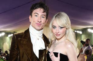 Barry Keoghan in a Victorian-inspired outfit and Sabrina Carpenter in a strapless gown with a voluminous blue train at a formal event
