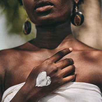 A model with a swatch of cream on the back of their hand