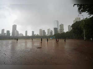 Children play in the rain in Mumbai