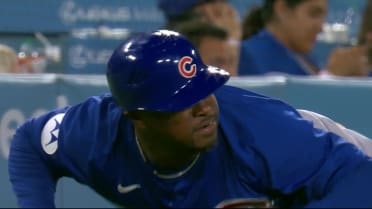 Cubs 3B Coach Willie Harris ducks under foul ball