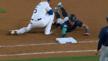 Dylan Moore safe at first after review