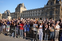 BTS' Jin carries Olympic torch near Louvre Museum