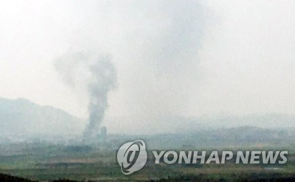 This photo provided by a reader shows smoke rising from North Korea's border city of Kaesong. (Yonhap)