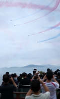 Black Eagles fly over sea fog