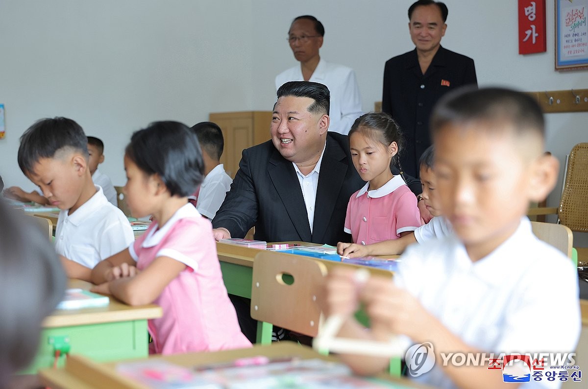 N. Korean leader with students from flood-hit region