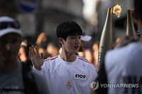 BTS' Jin carries Paris Olympics torch amid cheers from thousands of fans
