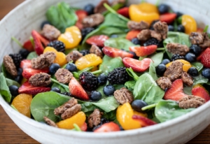 big bowl of spinach salad with berries.