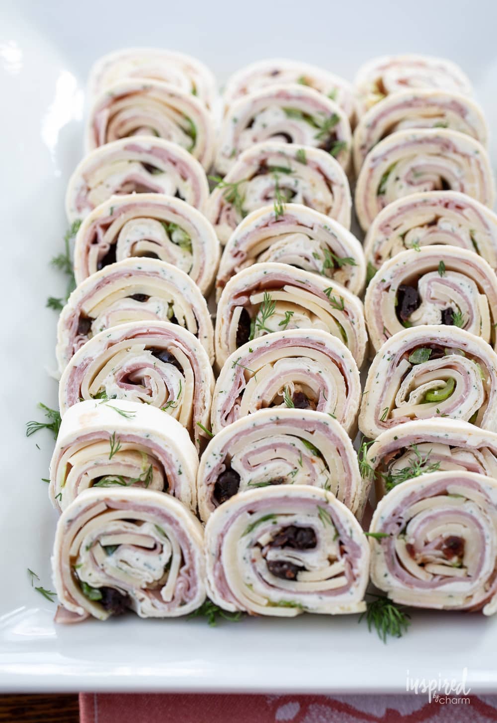 black forest ham pinwheels on a platter.