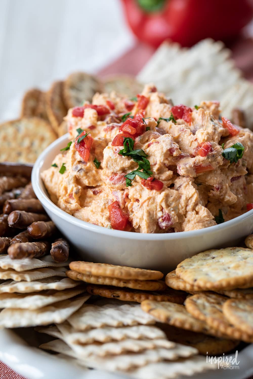 roasted red pepper dip served in a dish with cracker.s