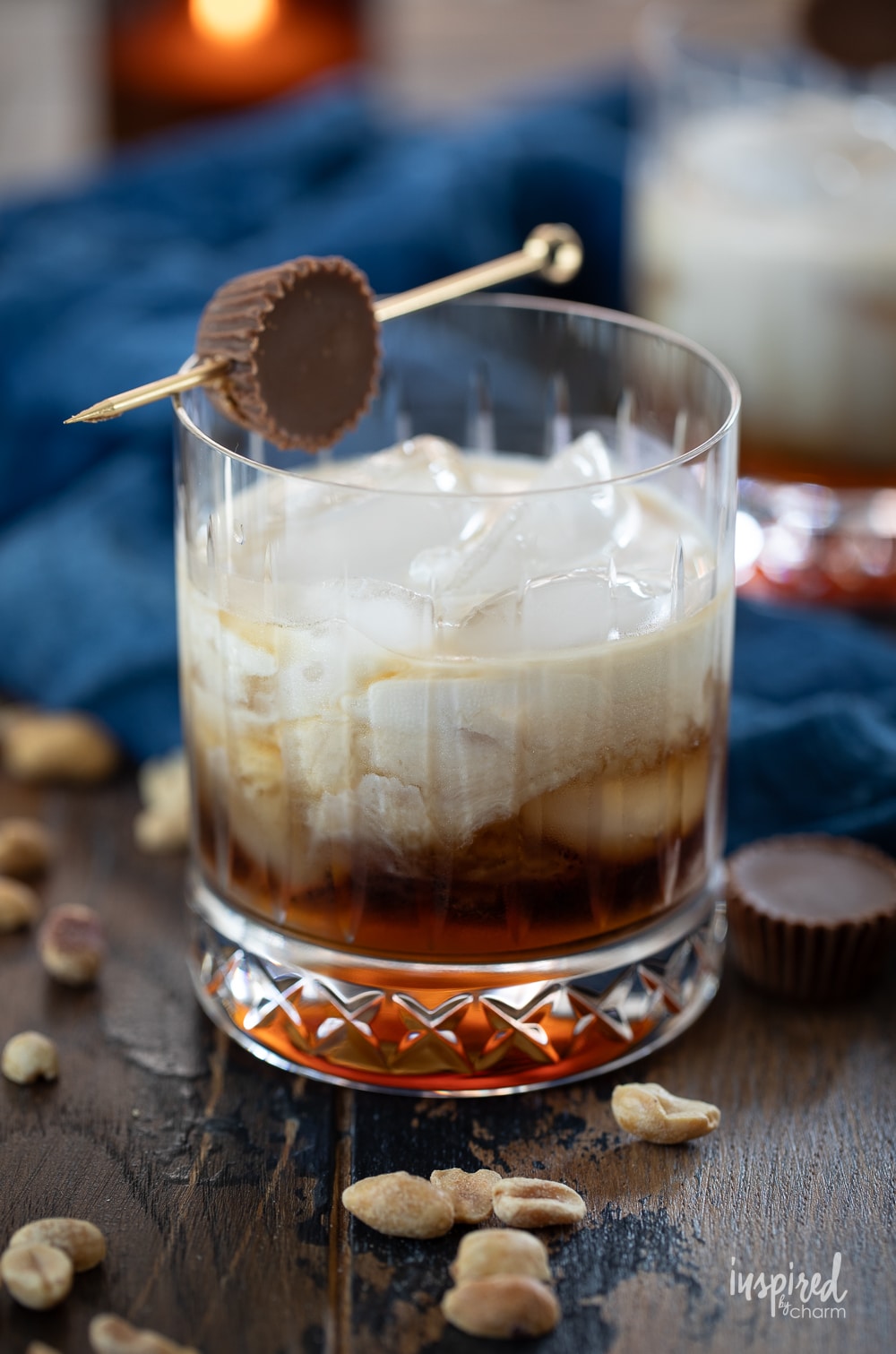 peanut butter white russian cocktail in a rocks glass with peanut butter cup garnish.