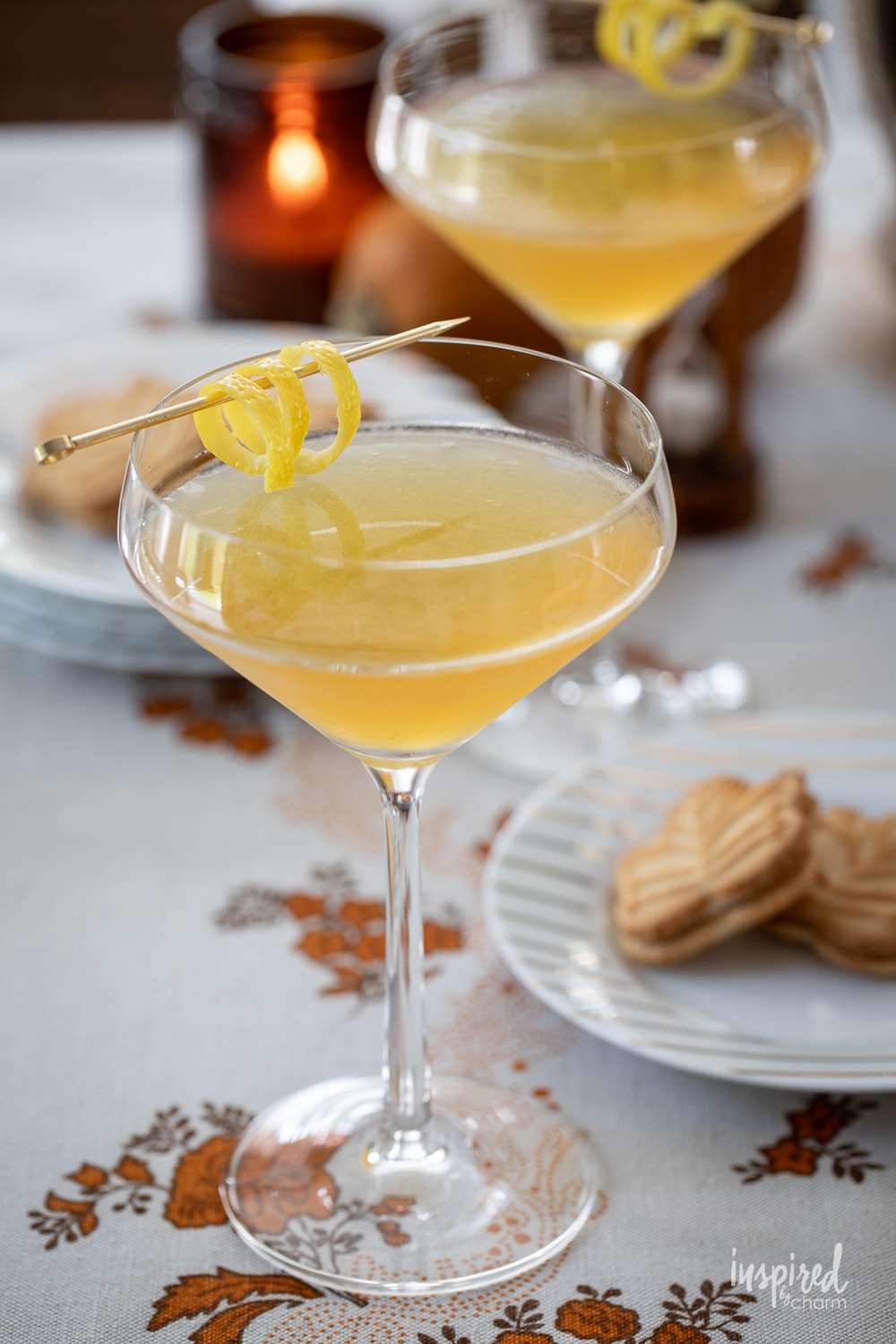 maple martini in a glass with fall decor around.