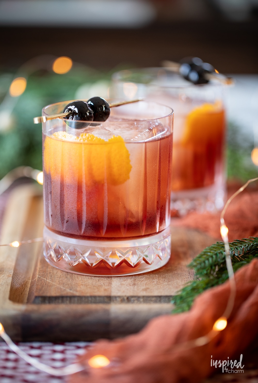 two festive dolomite old fashion cocktails in rocks glasses. 