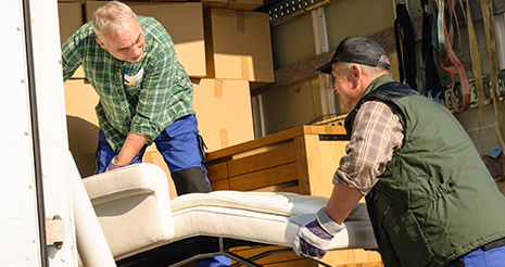 Movers keeping furniture and boxes in the truck