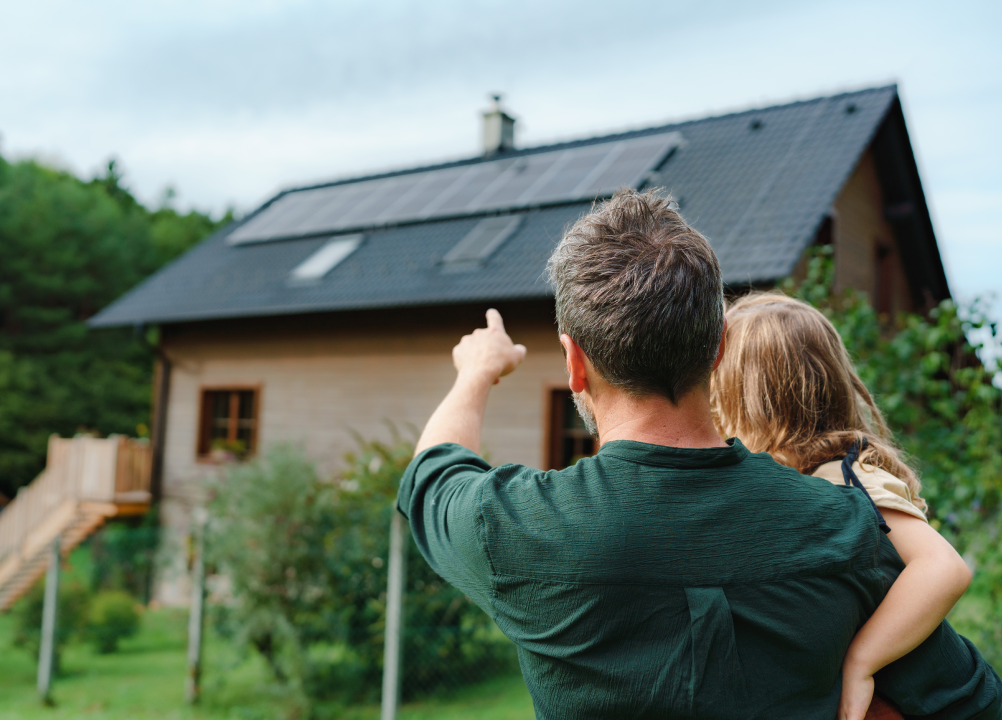 Famille regardant les panneaux solaires installés sur leur maison