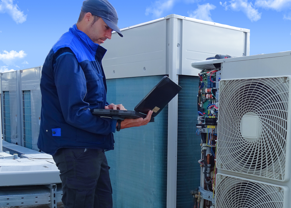 A technician working on a building’s HVAC system