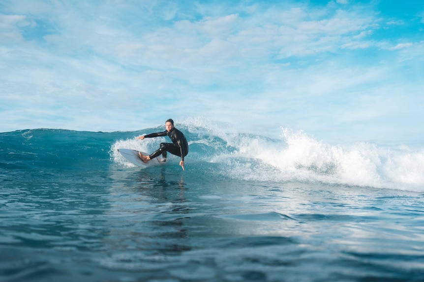 a surfer leaning into a wave