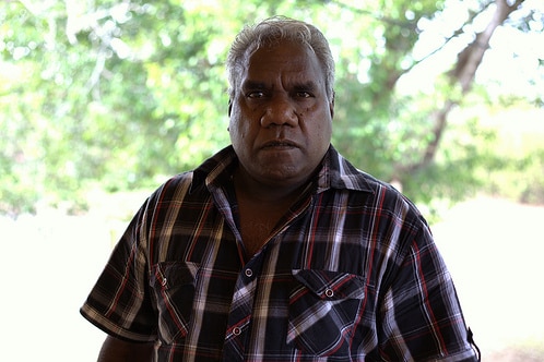 Tony Wurramarrba stands in front of trees.