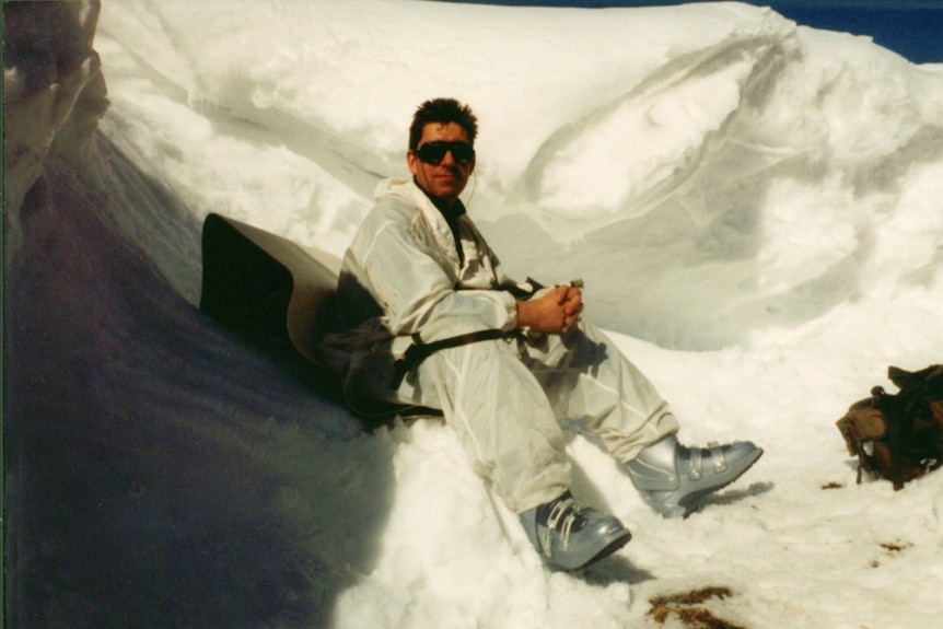 Adam wears protective gear on a snow-covered mountain