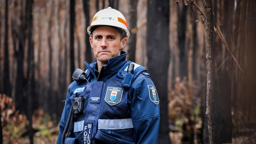 Brady Childs, authorised officer with the Conversation Regulator, pictured in a burnt-out forest. 