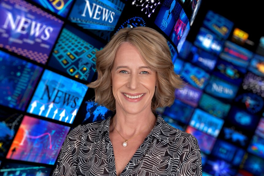 A blonde woman in business clothes smiles in front of a montage of screens, many of which say "News"