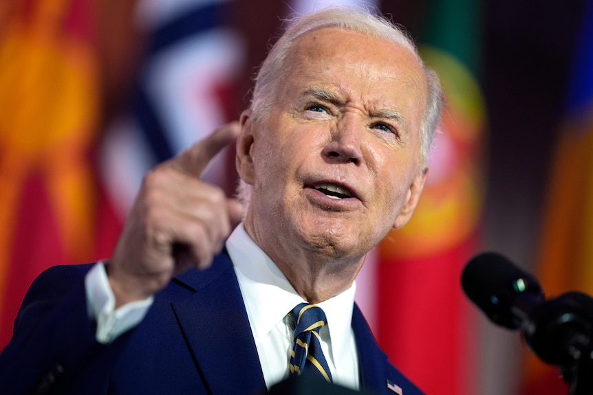 A close up of Joe Biden speaking passionately and pointing with his right hand