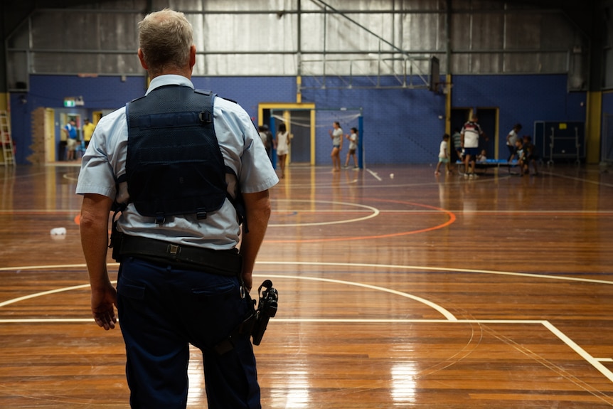 A Moree police officer playing goaltender at the PCYC hall