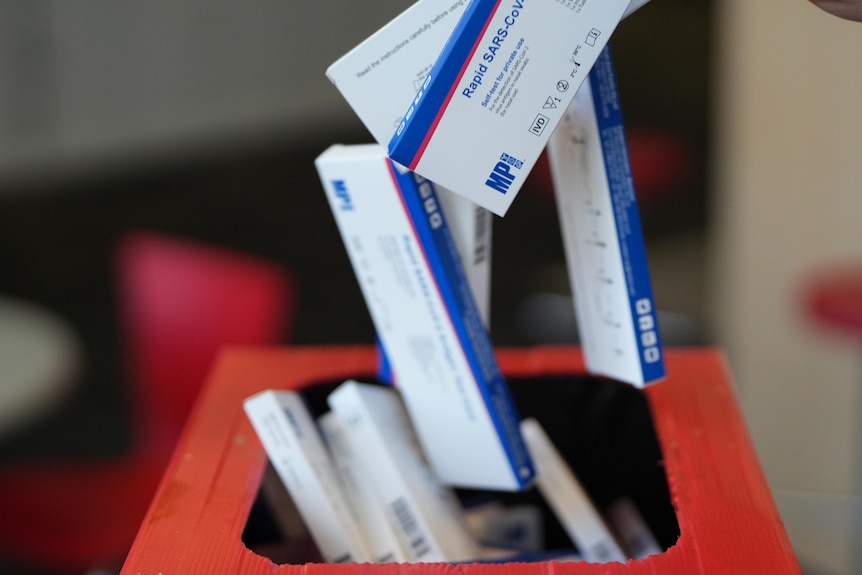 A motion blur image of rat tests being thrown in a bin