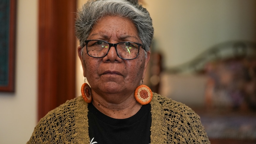 an Aboriginal woman with short grey hair wearing glasses