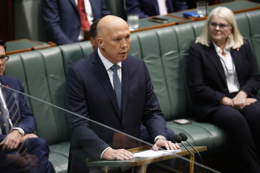 Peter Dutton standing at a lectern. 