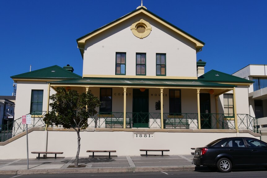 Exterior of a white courthouse building, viewed from the street.