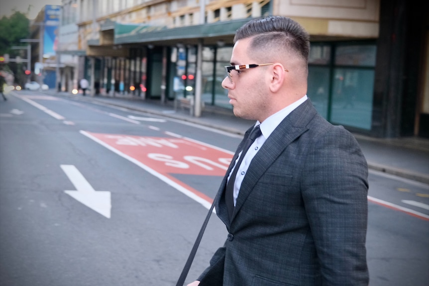 A man wearing a suit and tie and shades