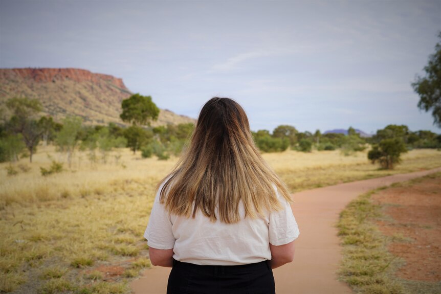 A woman looks out at a path