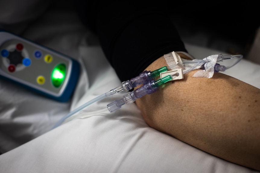 Needles in a patient's arm in hospital.