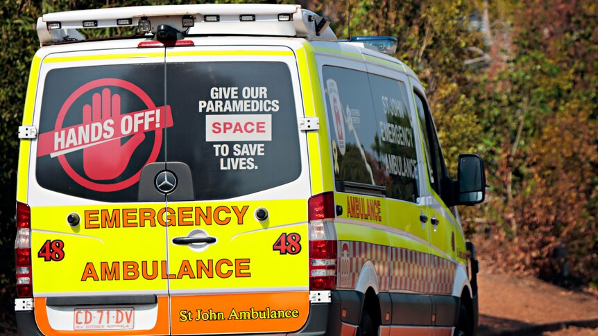 A St John Ambulance NT vehicle driving along a road in suburban Darwin.