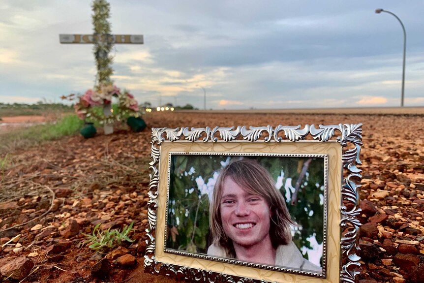 Image of a photograph of Josh Warneke placed in front of a memorial in Broome, Western Australia.