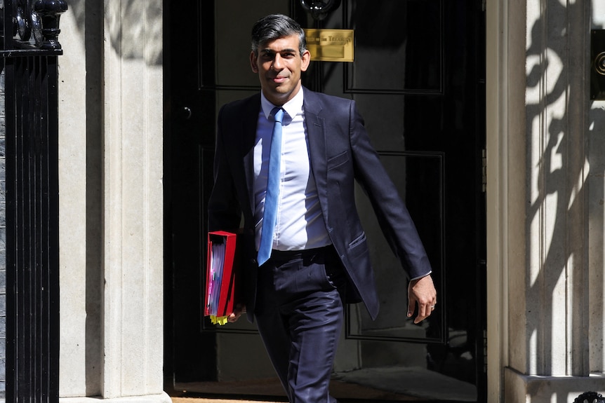 A man in a suit leaves an apartment.