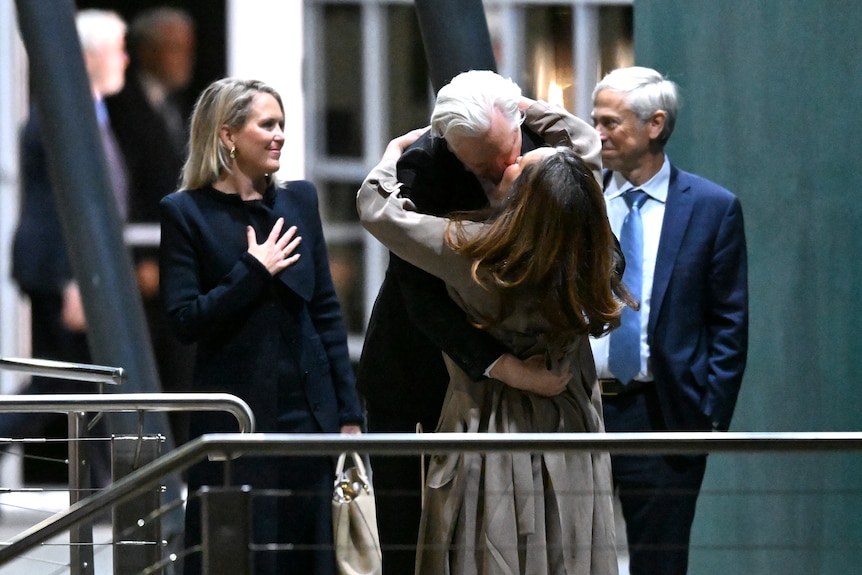 Julian and Stella embrace at Canberra Airport.